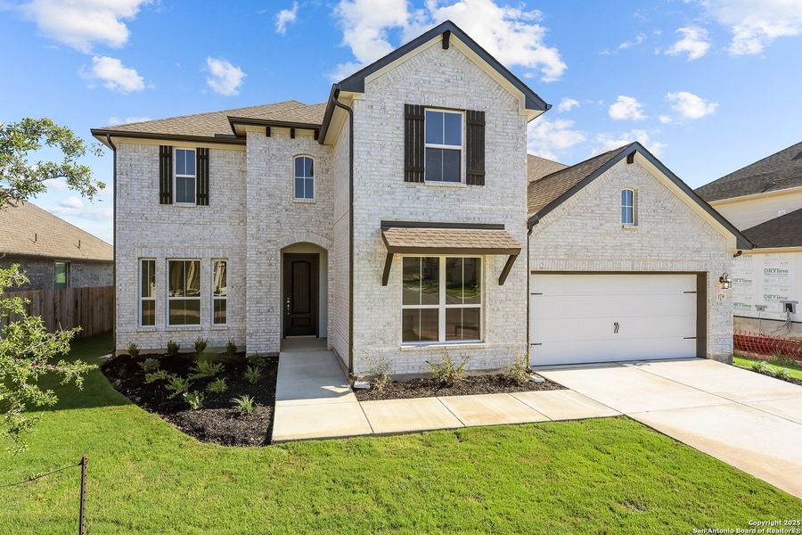 Front exterior of a new home in Megan's Landing 50', Castroville, TX, highlighting curb appeal (Image 19).