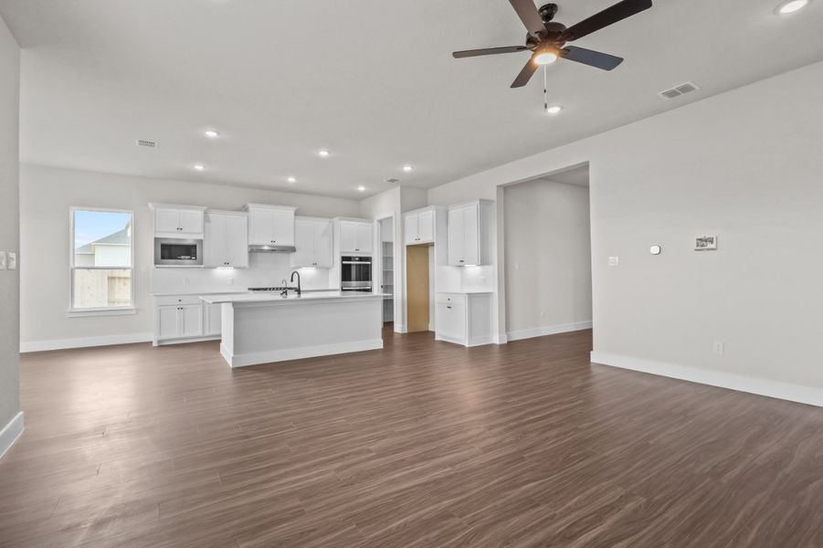 A large kitchen with white cabinets. A large kitchen with white cabinets.