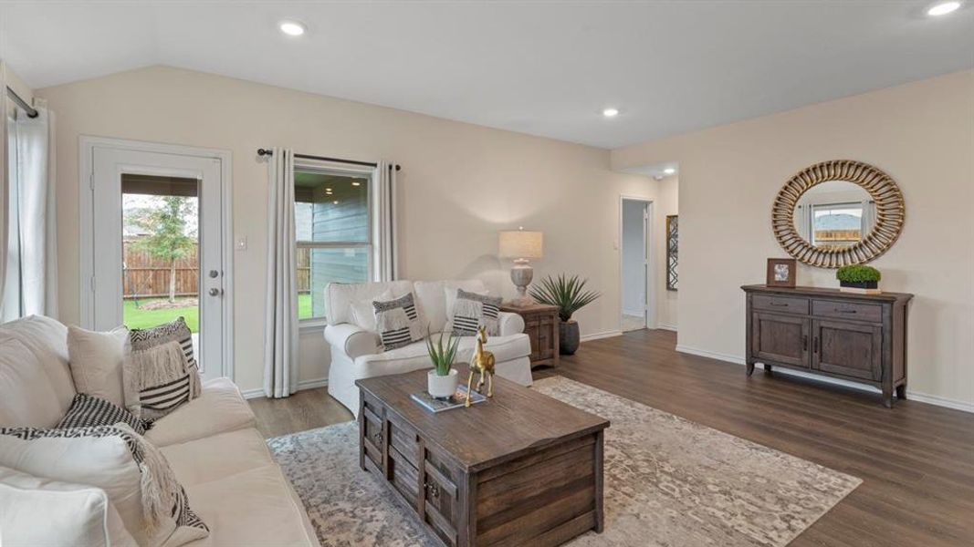 Living area with wood finished floors and recessed lighting