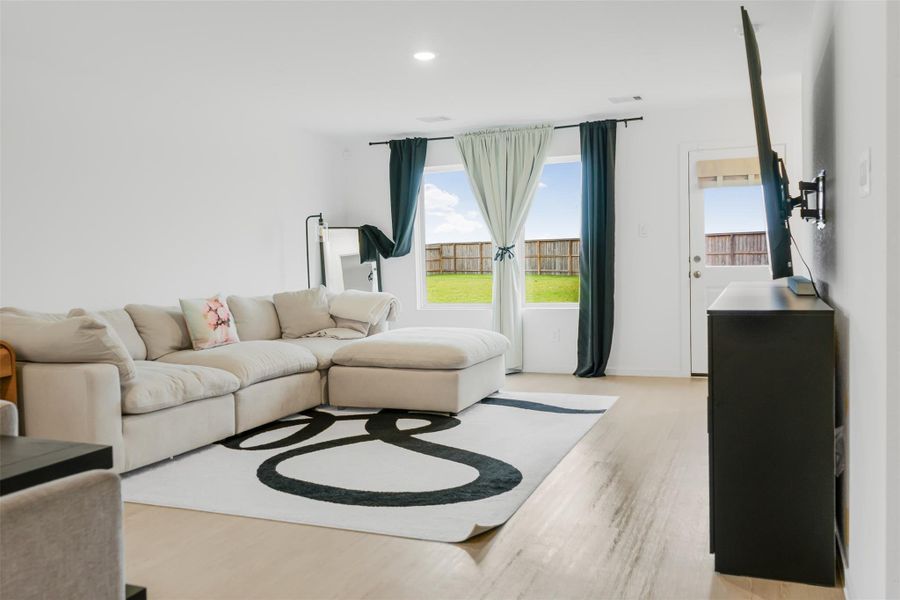 Large windows and a glass door offer plenty of natural light and views of the backyard.