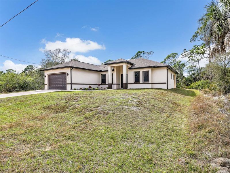 Front exterior of a new home in , Port Charlotte, FL, highlighting curb appeal (Image 26).
