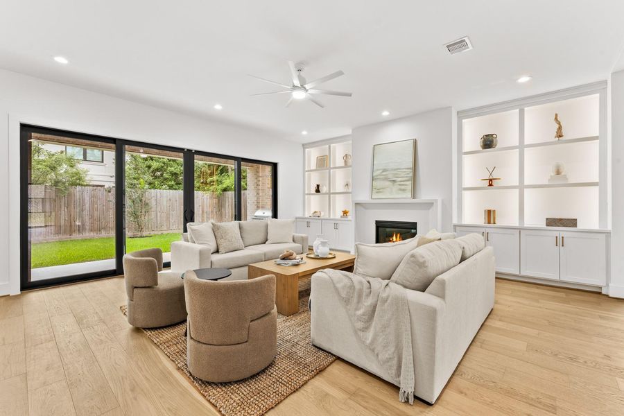 Styled shelving to create a curated feel without clutter. Lower cabinets provide hidden storage, enhancing functionality. Large glass sliding doors to backyard and summer kitchen.