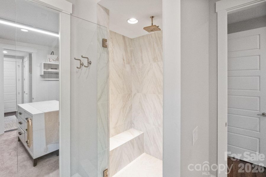 Large Primary Bathroom has dual vanities, quartz counters and large walk-in shower.