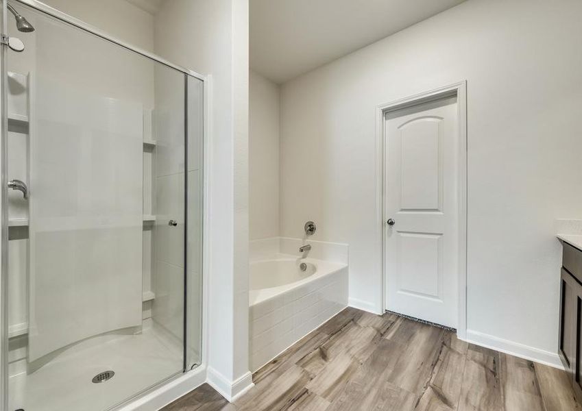 The master bath has a glass enclosed shower and large soaker tub.