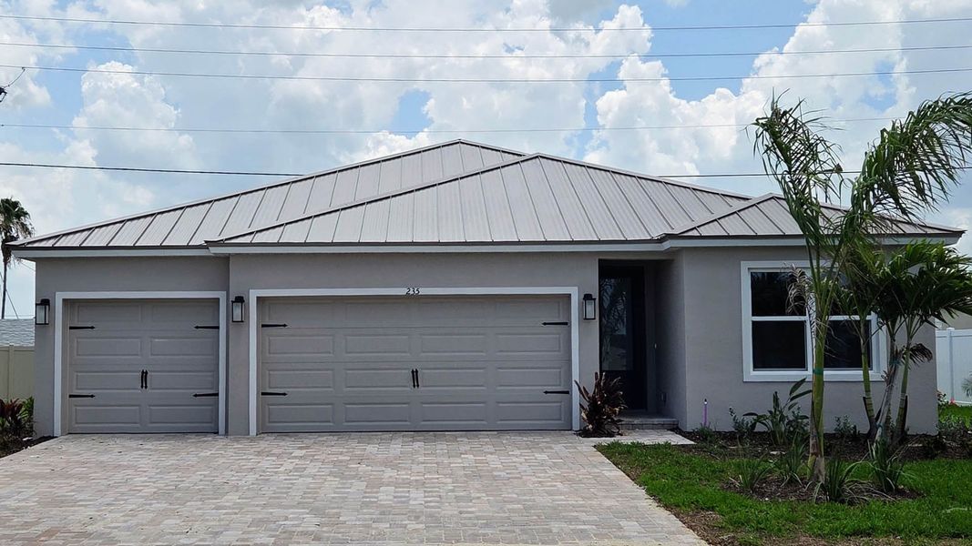 Front exterior of a new home in Riverwalk of Cocoa, Cocoa, FL, highlighting curb appeal (Image 1). Front exterior of a new home in Riverwalk of Cocoa, Cocoa, FL, highlighting curb appeal (Image 1).