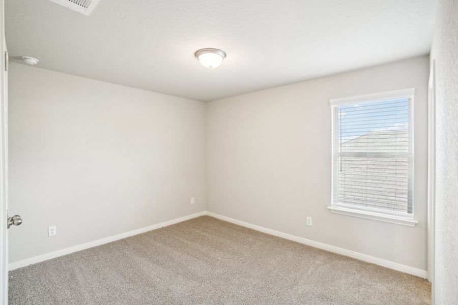 Guest bedroom of the Reynolds floorplan at a Meritage Homes community.