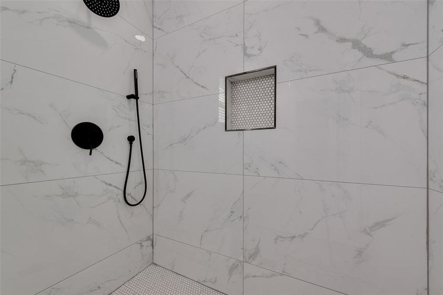 Bathroom featuring a tile shower