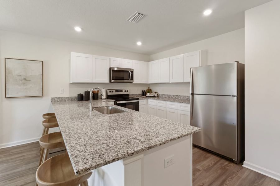 A kitchen with white cabinets. A kitchen with white cabinets.