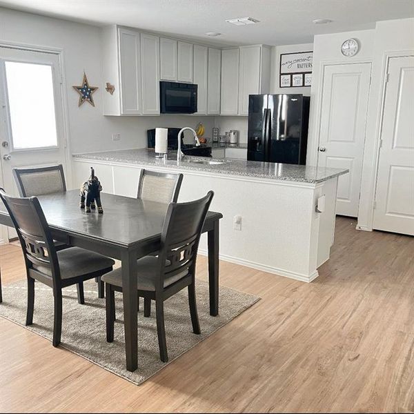 Dining space with light wood finished floors Dining space with light wood finished floors