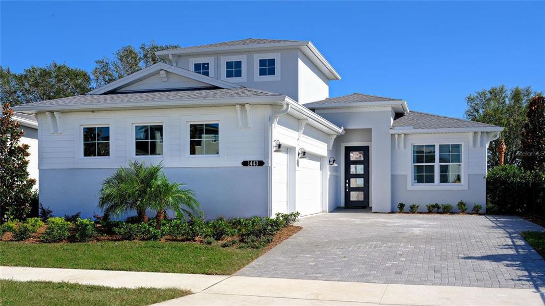 Front exterior of a new home in Cresswind at Lake Harris, Tavares, FL, highlighting curb appeal (Image 1).