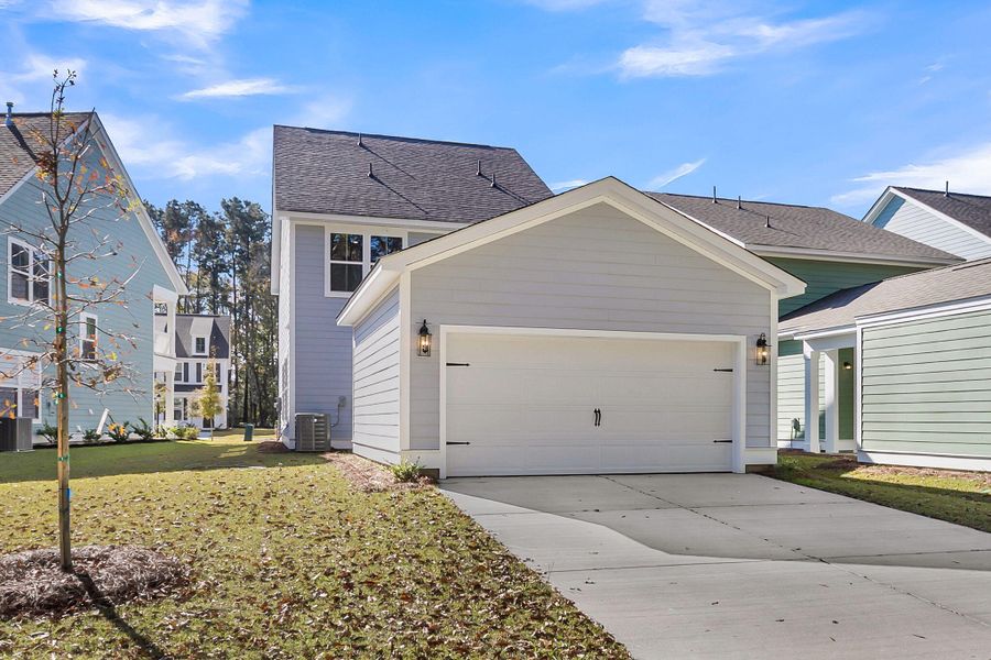 Front exterior of a new home in Sweetgrass Station, Summerville, SC, highlighting curb appeal (Image 26).