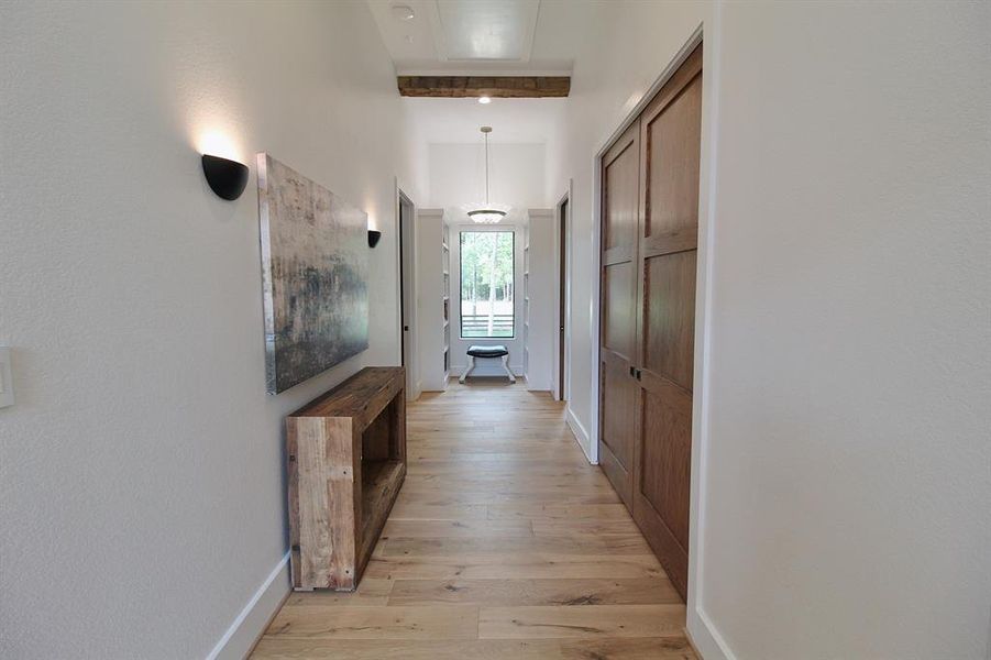 Spacious hallway that connects to all secondary bedrooms and features a large overflow closet with steam closet.