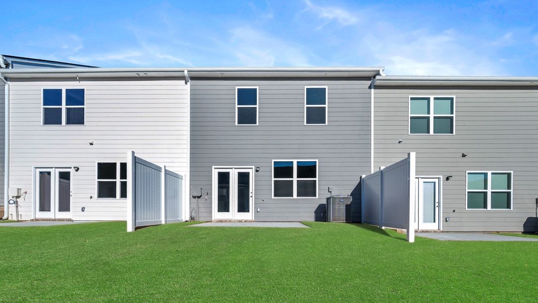 Exterior details and patio area of a home in Inverness at Sugarloaf, Lawrenceville (Image 3).