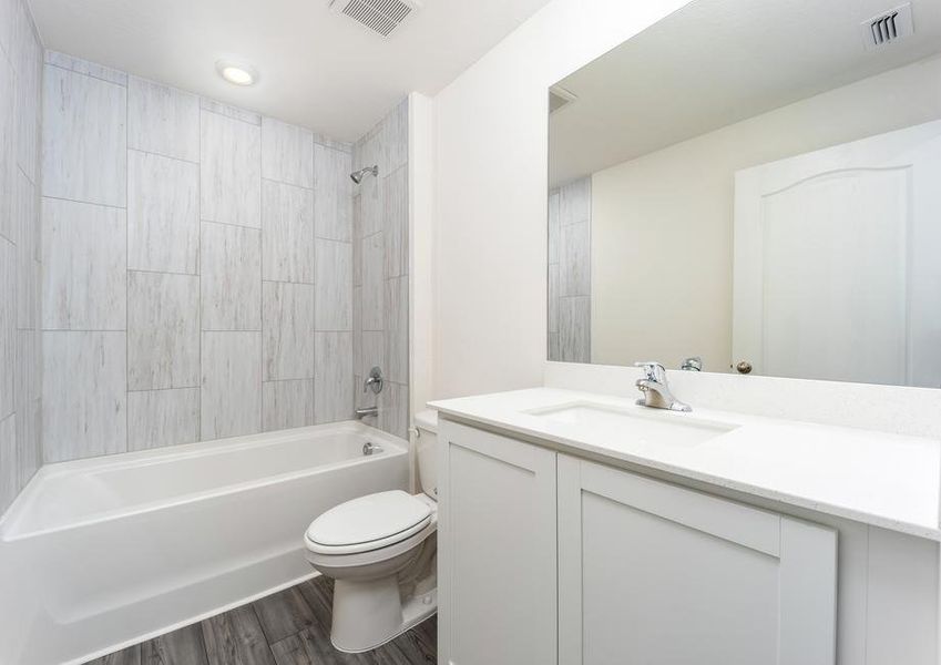 A spacious secondary bathroom with tile detail