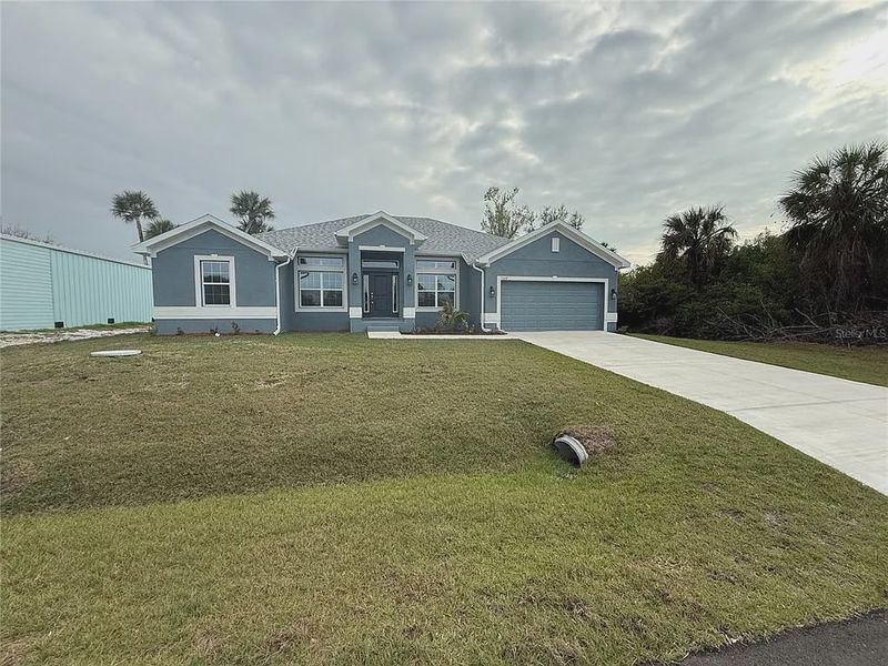 Front exterior of a new home in South Gulf Cove, Port Charlotte, FL, highlighting curb appeal (Image 2). Front exterior of a new home in South Gulf Cove, Port Charlotte, FL, highlighting curb appeal (Image 2).