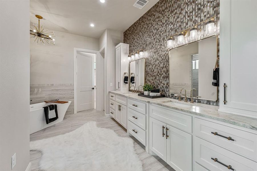 Bathroom featuring tile walls, a washtub, and double sink vanity