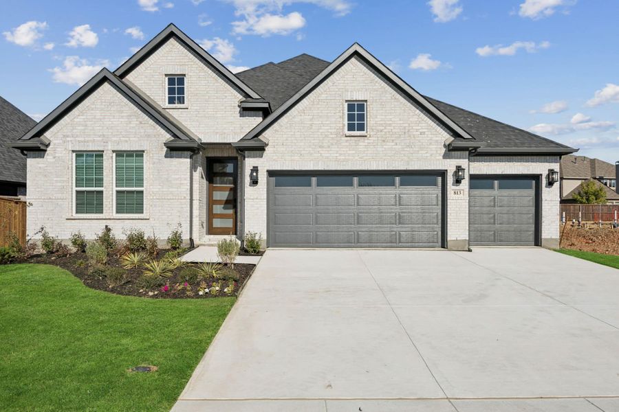 Front exterior of a new home in Las Lomas, Forney, TX, highlighting curb appeal (Image 1). Front exterior of a new home in Las Lomas, Forney, TX, highlighting curb appeal (Image 1).