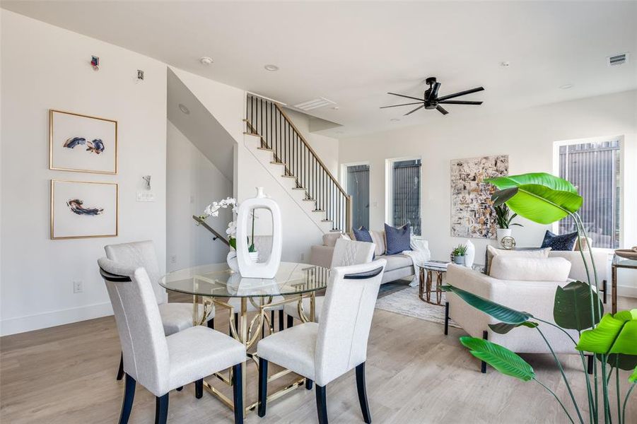 Dining room with ceiling fan and light hardwood / wood-style flooring