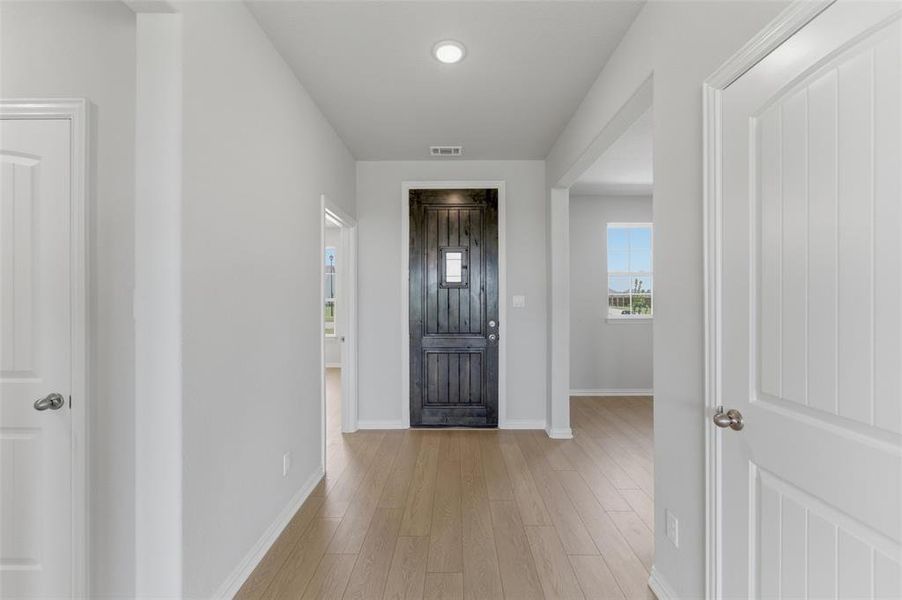 Entryway featuring a dark-stained paneled front door with clear glass insert Entryway featuring a dark-stained paneled front door with clear glass insert
