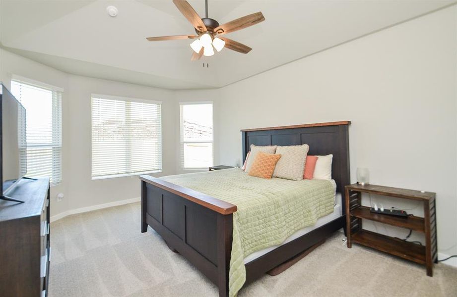 Spacious downstairs primary bedroom is large enough to accommodate a sitting area.