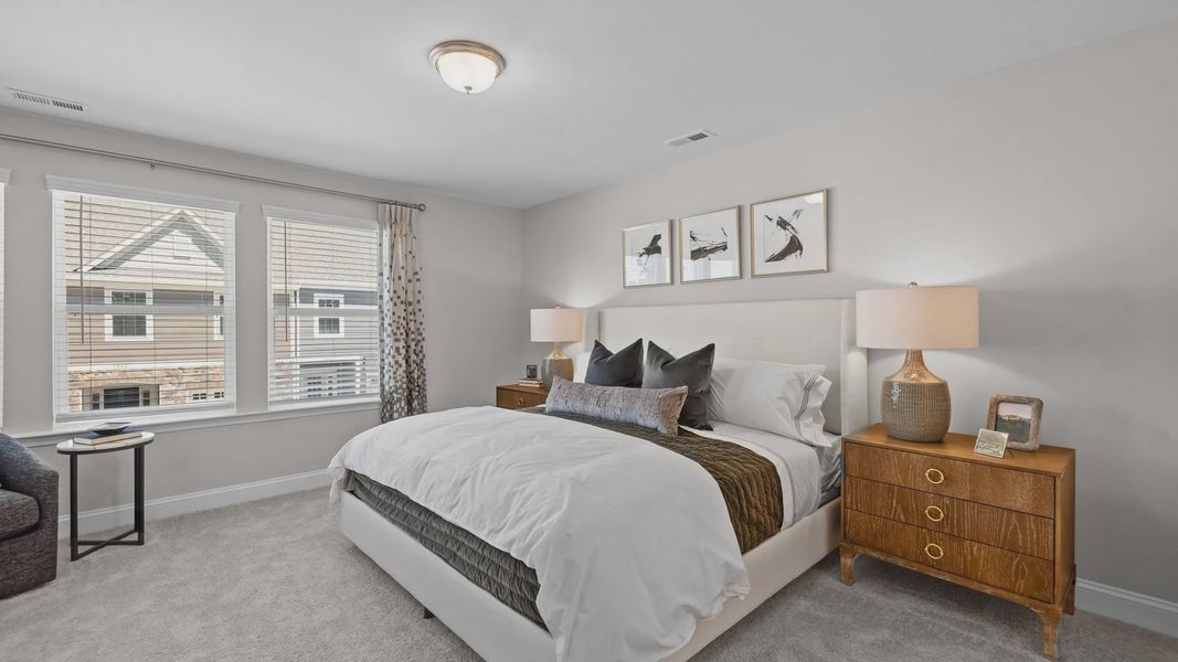 Spacious bedroom with large windows and plush carpeting in the Rochester Design by DRB Homes Charlotte, NC Spacious bedroom with large windows and plush carpeting in the Rochester Design by DRB Homes Charlotte, NC