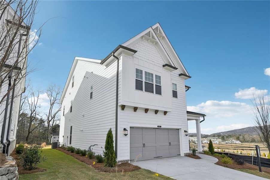 Front exterior of a new home in Palisades Single Family, Cumming, GA, highlighting curb appeal (Image 21).