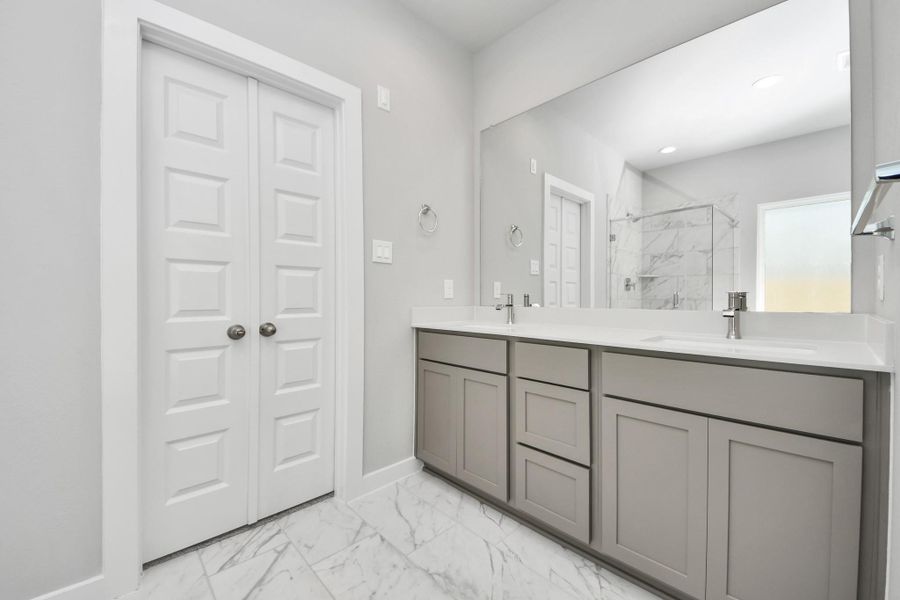 Elevate your daily routine at the elegant vanity, now equipped with double sinks, light countertops, modern hardware, and beautiful recessed lights. Sample photo of completed home with similar floor plan. Actual colors and selections may vary. Elevate your daily routine at the elegant vanity, now equipped with double sinks, light countertops, modern hardware, and beautiful recessed lights. Sample photo of completed home with similar floor plan. Actual colors and selections may vary.