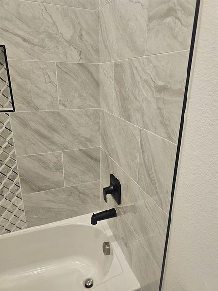 Details with tiled shower / bath