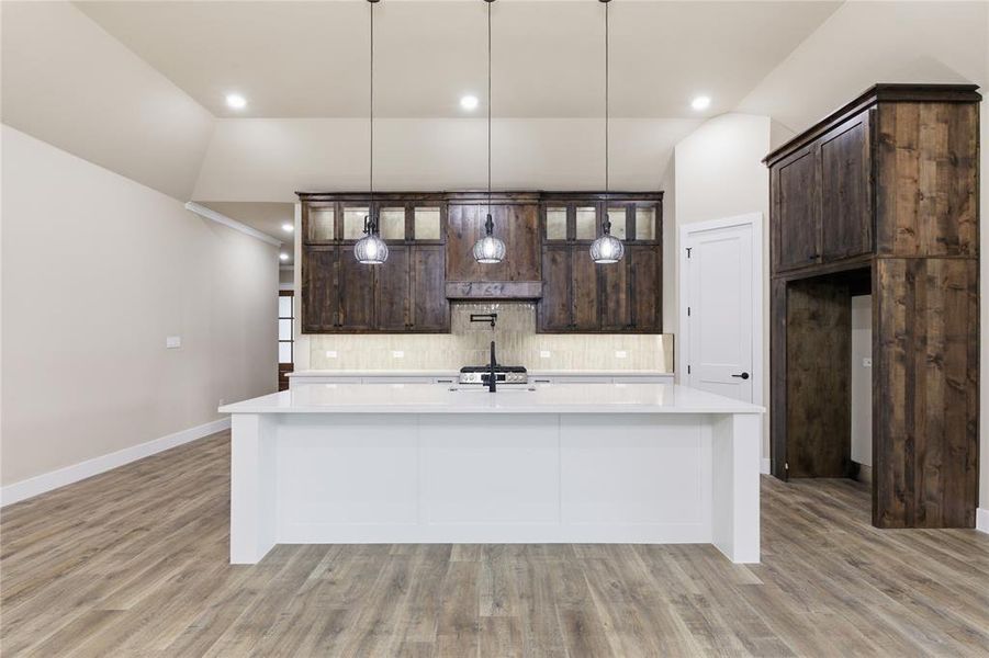 Kitchen featuring an expansive center island with a white countertop Kitchen featuring an expansive center island with a white countertop