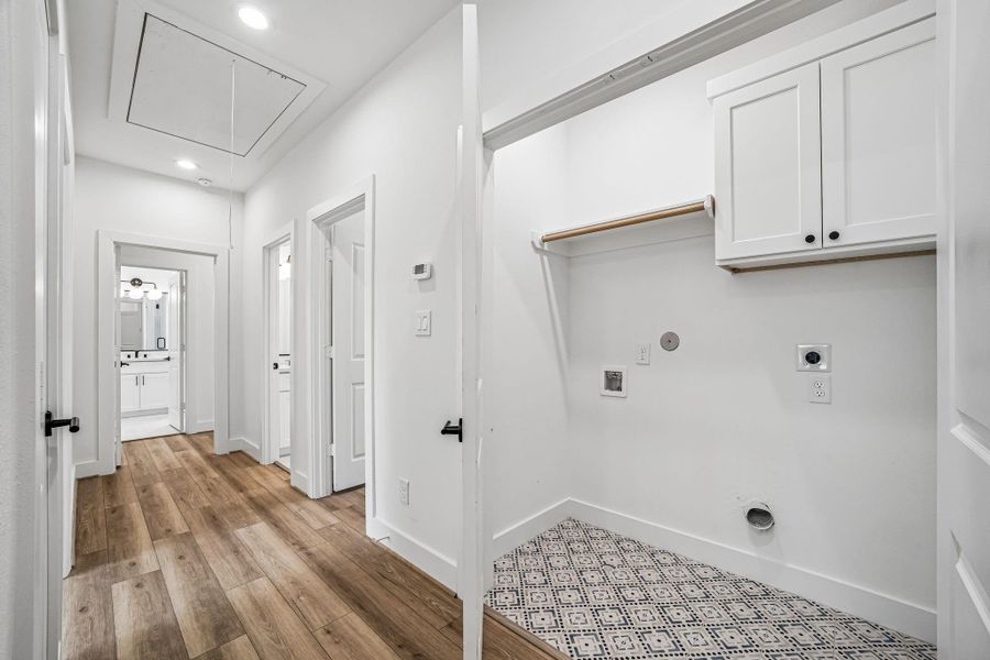 Laundry Room with accent tile and built in cabinets.