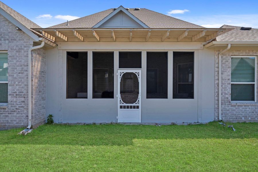 Covered and screened patio area providing a comfortable, shaded outdoor retreat with added privacy.