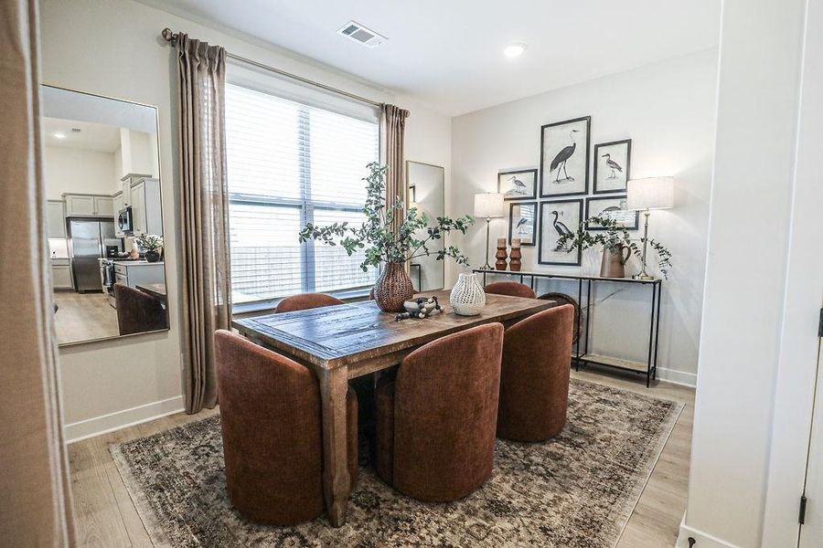 Dining room featuring wood finished floors and recessed lighting