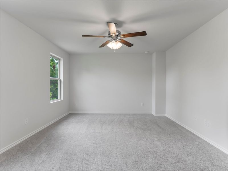 Cozy upstairs bedroom featuring plush carpet for added comfort.