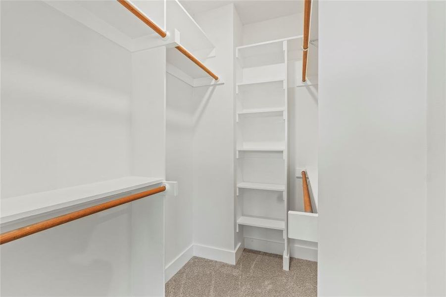 Spacious closet featuring light colored carpet Spacious closet featuring light colored carpet