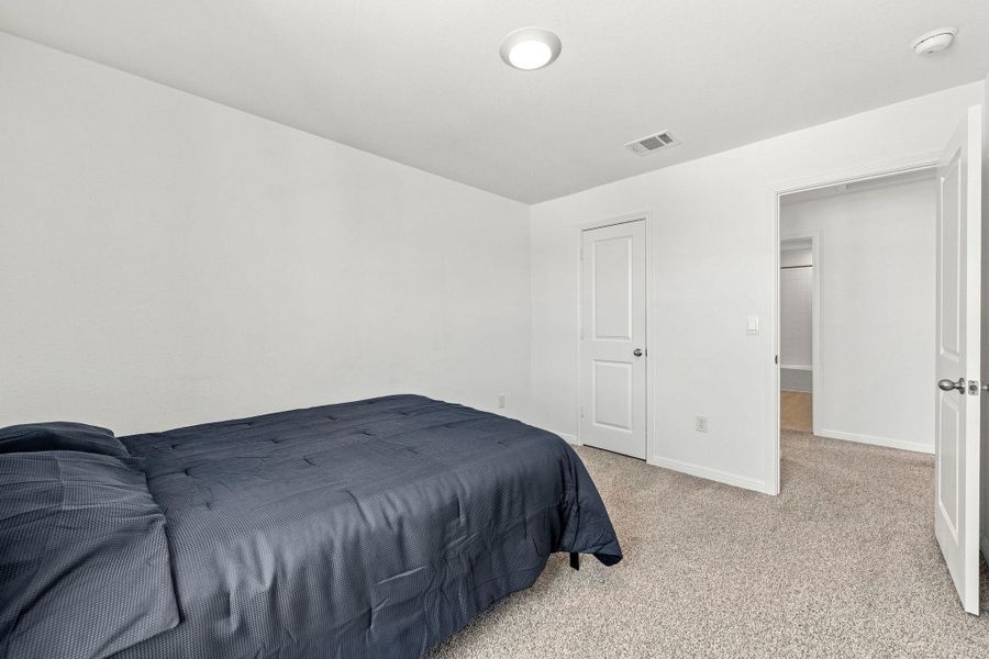 Crisp walls and plush carpeting define this serene private retreat.