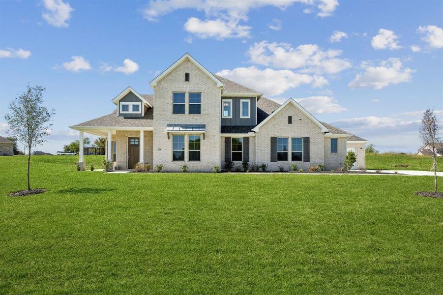 View of front of property with a front lawn, brick siding, and a porch