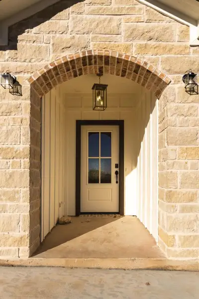Doorway to property featuring stone siding