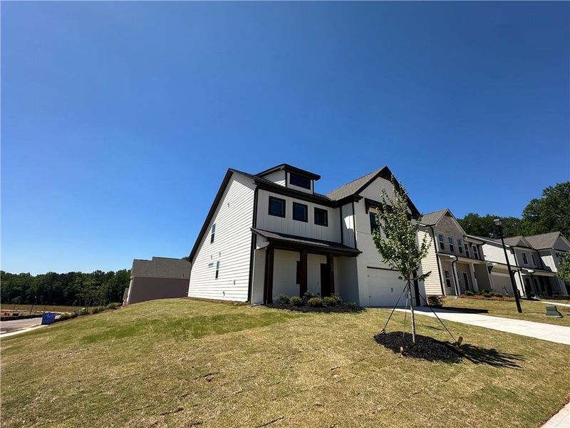 Front exterior of a new home in Summerlin, Winder, GA, highlighting curb appeal (Image 24).