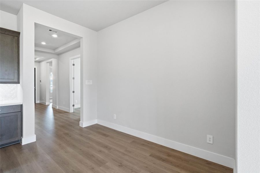 The breakfast nook is a natural extension of the kitchen and living room, allowing for seamless conversation and connection with guests or family members, even when preparing a meal.