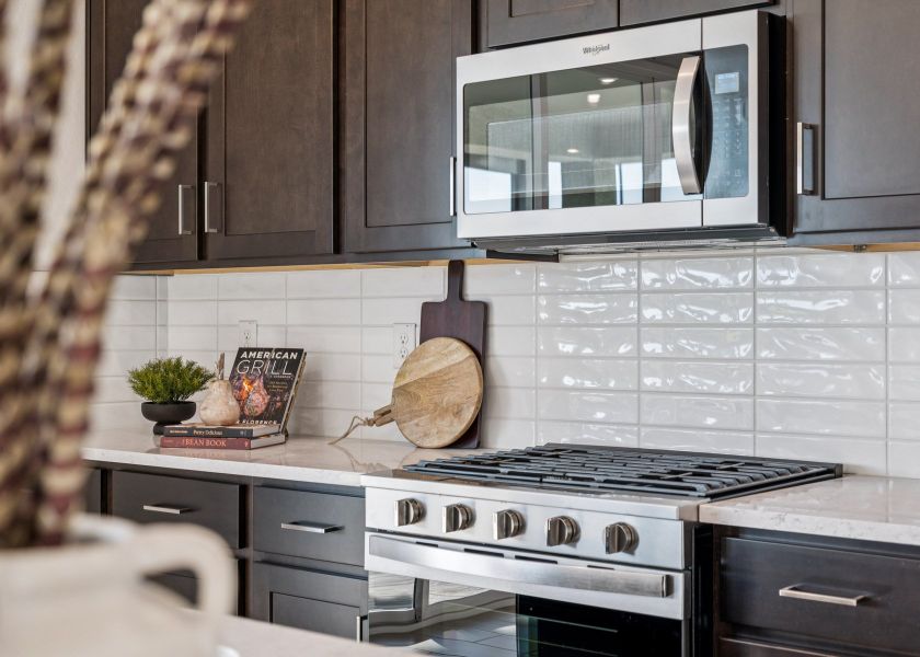 A kitchen with a microwave oven and a wood stove.