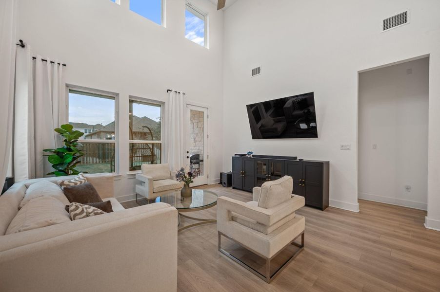 Living room with high ceilings and second story living area open to below