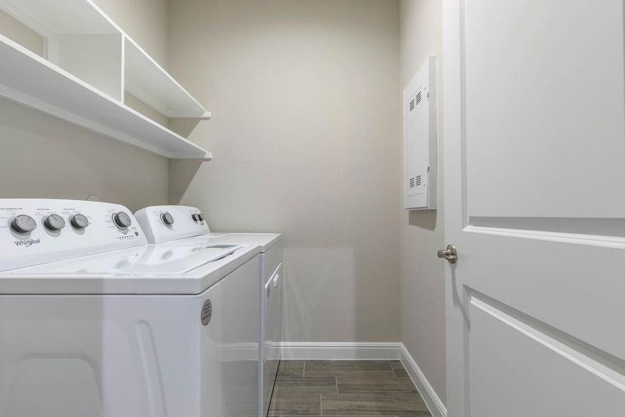 Laundry area with washing machine and dryer and wood tiled floors Laundry area with washing machine and dryer and wood tiled floors