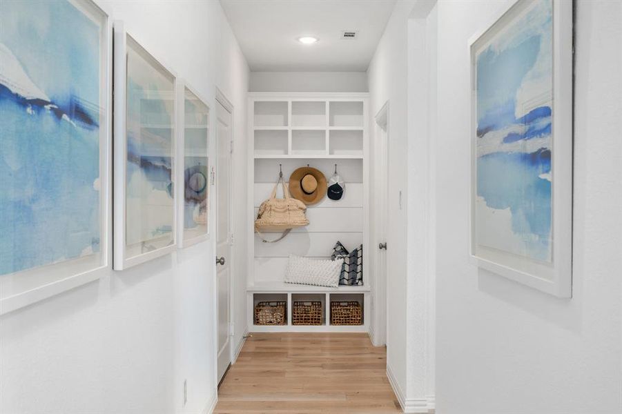 Mudroom with light hardwood / wood-style flooring