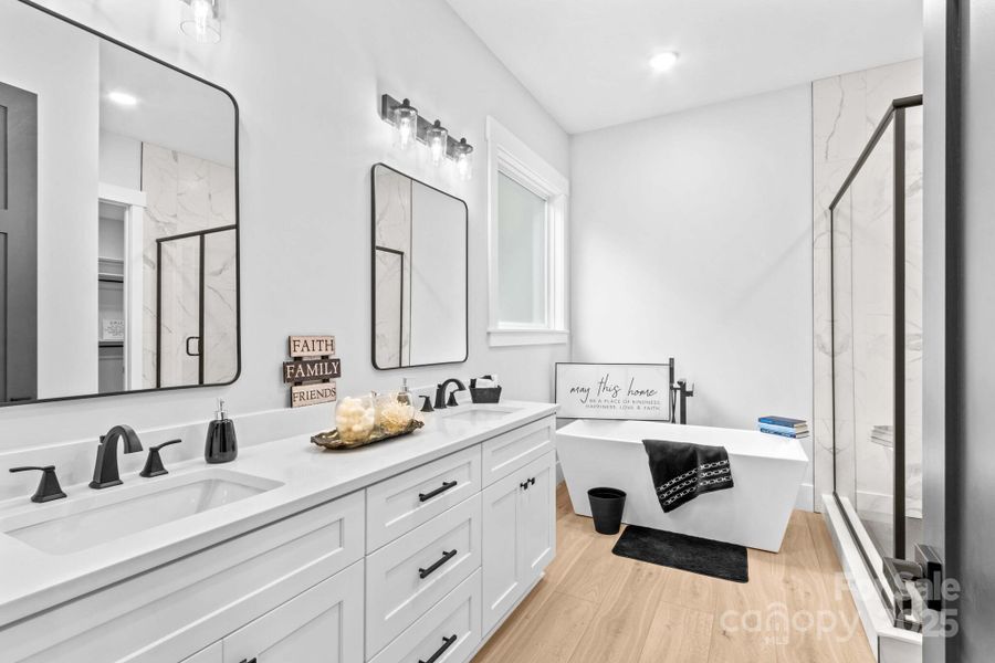 Main Spa inspired Bath with quartz vanities & waterproof LVP flooring, designer mirrors & upscale cabinetry.