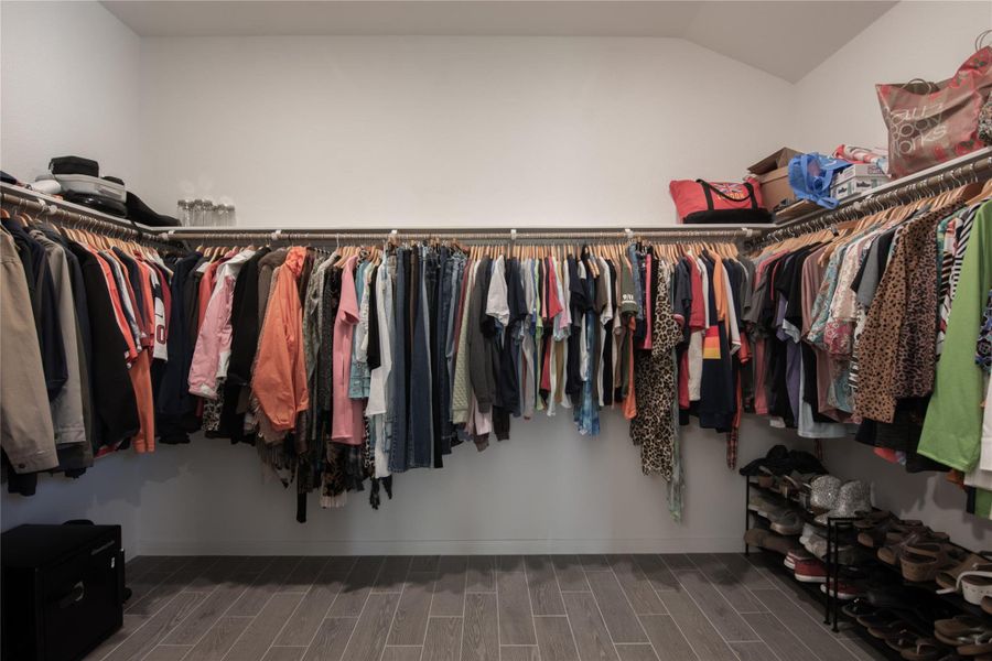 Spacious walk-in closet with ample hanging space and organized shelving for shoes and accessories.