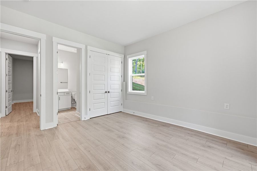 Smooth wood flooring and pristine white trim ancho