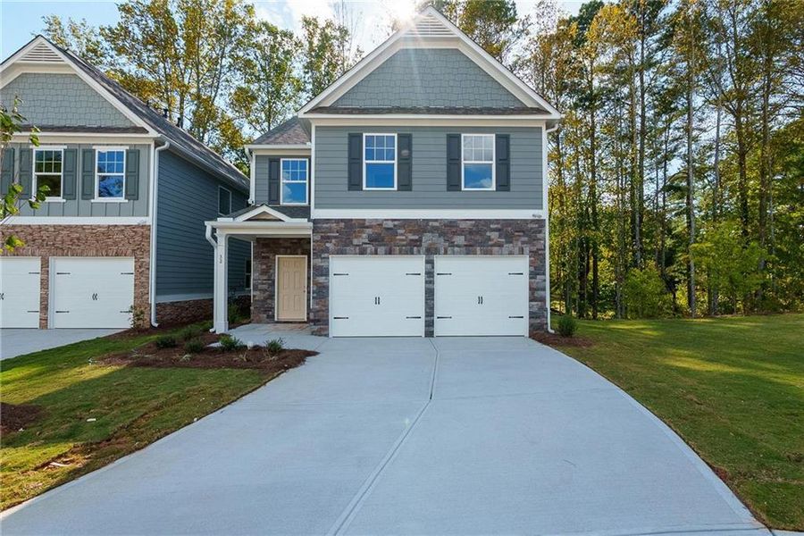 Front exterior of a new home in Castleberry Pointe, Dawsonville, GA, highlighting curb appeal (Image 1). Front exterior of a new home in Castleberry Pointe, Dawsonville, GA, highlighting curb appeal (Image 1).