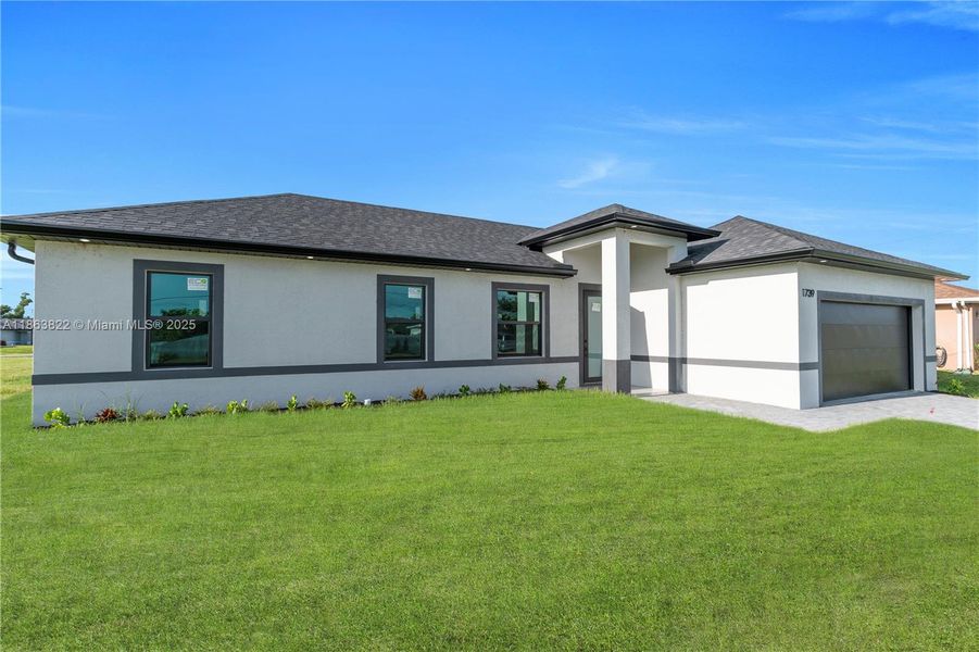 Front exterior of a new home in , Cape Coral, FL, highlighting curb appeal (Image 19). Front exterior of a new home in , Cape Coral, FL, highlighting curb appeal (Image 19).