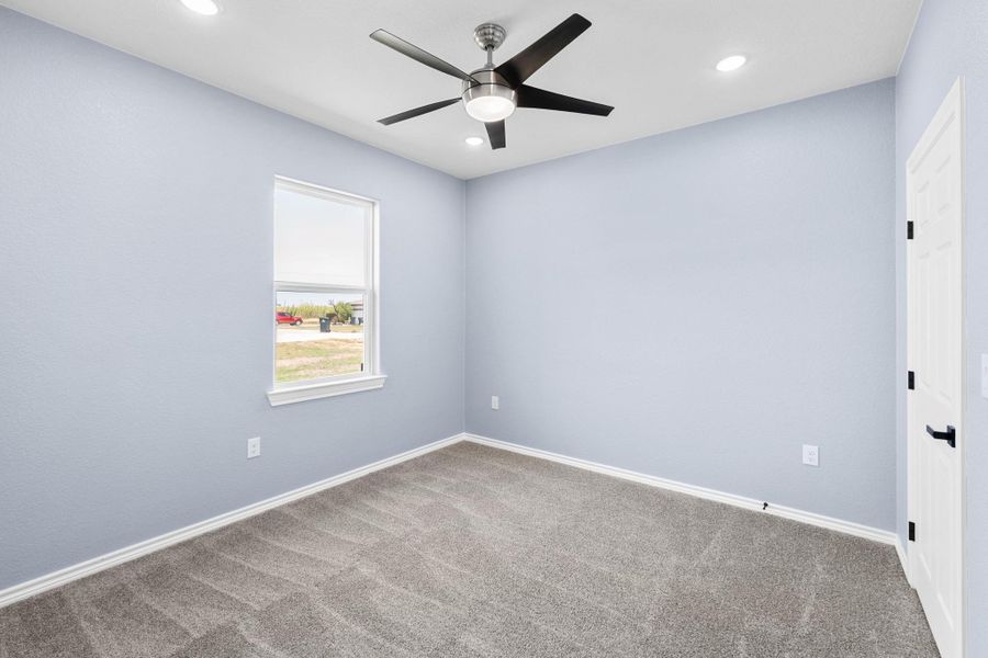 Carpeted empty room featuring ceiling fan and recessed lighting Carpeted empty room featuring ceiling fan and recessed lighting