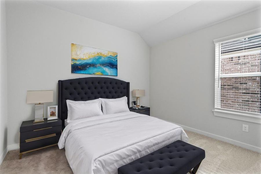 Secondary bedroom features plush carpet, custom paint, lighting, and a large window with privacy blinds.